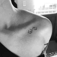 black and white photo of a woman's shoulder with the letter f on it