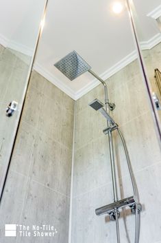 a shower head and hand shower in a bathroom