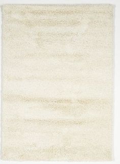 a white area rug on top of a wooden floor