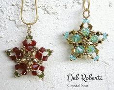 two necklaces with different colored stones hanging from hooks on a white wall and the words deb robert crystal star written below them