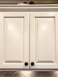 white cabinets with black knobs in a kitchen