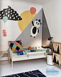 a child's bedroom decorated in black, white and yellow with an animal theme