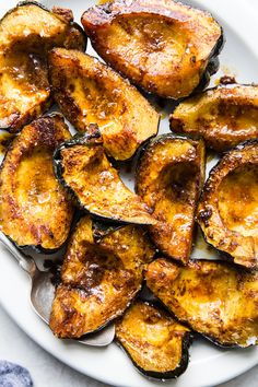 a white plate topped with fried bananas on top of a table