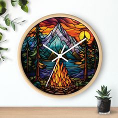 a clock that is on the wall next to a potted plant and some plants