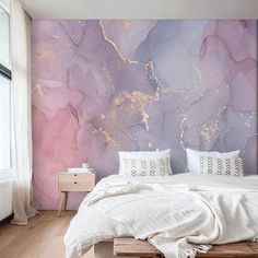 a bed sitting under a purple and gold wall mural