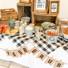 a table topped with lots of food next to wooden crates filled with fruits and vegetables