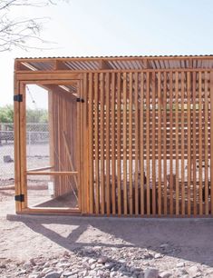 a wooden structure sitting on top of a dirt field