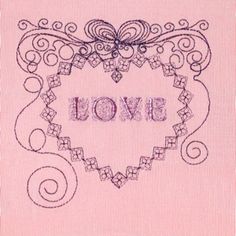 an embroidered heart with the word love written in cursive writing on pink fabric