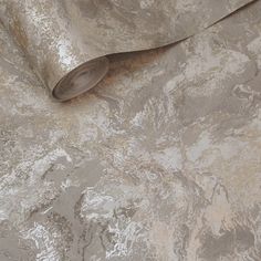 a silver and gold wallpaper with an interesting pattern on it's surface that looks like marble