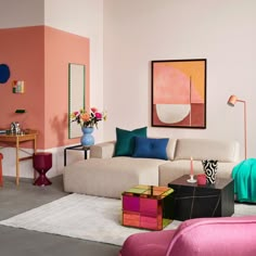 a living room filled with lots of furniture and colorful pillows on top of it's couches