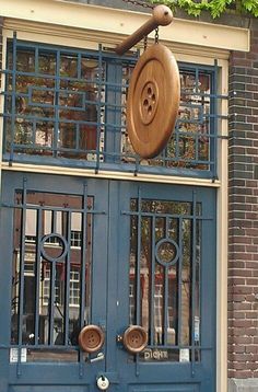 a blue door with an iron grill on the outside and wooden doors at the top