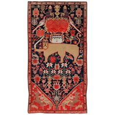 an antique persian rug with animals and flowers on the border, is shown in red