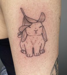 a rabbit with a hat on it's head is shown in this tattoo design