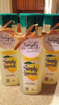 four empty lemonade bottles with brown ribbon tied around them on a kitchen countertop