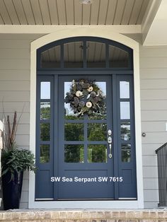 a blue front door with a wreath on it