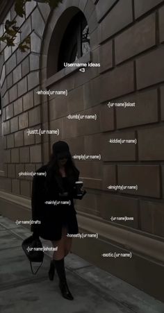 a woman is walking down the sidewalk with her cell phone in hand and text on the wall behind her