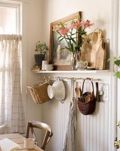 a shelf with pots, pans and utensils hanging from it's sides