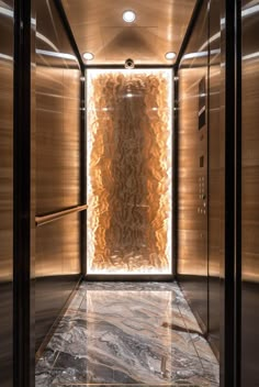 an elevator with marble floors and walls