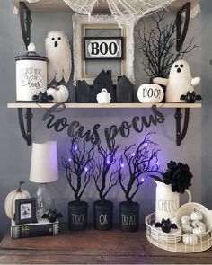 a shelf with halloween decorations on it and some lights in the shape of ghost's