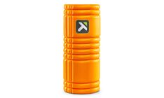 an orange foam yoga mat with the letter k on it's side, in front of a white background