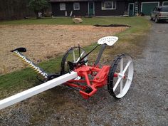 a red and white bike with wheels on the ground