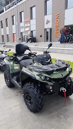 an atv is parked in front of a building