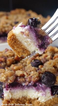 a close up of a piece of cake with blueberries and crumbs on it