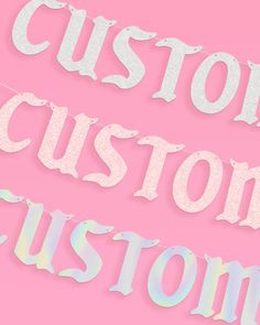 the words custom cut out on pink paper are shown in white and silver glitters