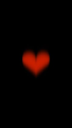 a red heart is seen in the dark