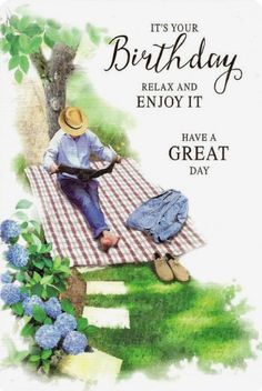 a birthday card with an image of a man sitting on a picnic blanket next to a tree