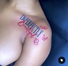 a woman's breast with the word identity tattooed on her left side and butterflies around it