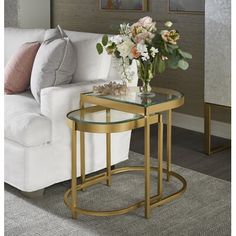 a living room scene with focus on the end table and flowers sitting on top of it