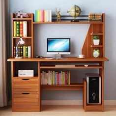 a desk with a computer and bookshelf on top of it in front of a window