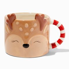 a ceramic mug with a deer design on it's face and red striped handles