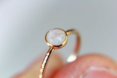 "This flash rainbow moonstone ring has a subtle, lux feel to it. I have set this 5mm round smooth rainbow moonstone gemstone into a solid 14kt yellow bezel cup with a thicker band ring. The 16 gauge solid 14kt yellow band has been also highly polished for a very reflective shine. This listing is for 1, 5mm rainbow moonstone ring. Material Information: Clarity: Occlusioned Color: rainbow Gemstone: moonstone Metal: 14kt yellow gold Handcrafted band: 16 gauge (1.4mm) faceted Please contact me with White Minimalist Moonstone Promise Ring, Minimalist White Moonstone Promise Ring, Minimalist White Moonstone Ring, Minimalist Round Moonstone Opal Ring, Modern Moonstone Promise Ring, Round Shape, White Moonstone Ring With Moon Phase Detail, White Moonstone Ring With Bezel Setting, Modern Round Moonstone Promise Ring, Dainty White Moonstone Ring With Round Band