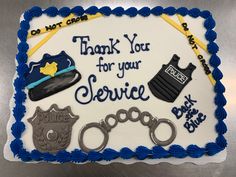 a birthday cake for a police officer with handcuffs, hats and other items on it