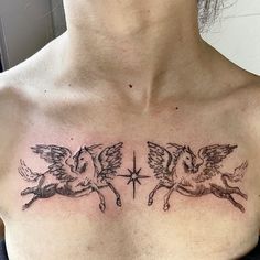 a woman's chest with two angels and a star tattoo on her left side