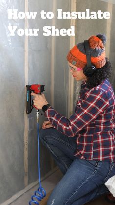 a woman in plaid shirt and ear muffs working on an electrical device with text overlay that reads how to insulate your shed