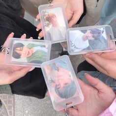 four people holding small plastic tags with pictures on them