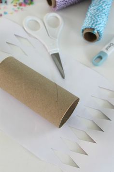 scissors, thread and paper on a table