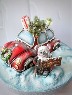 there is a cake that looks like a car with a santa clause on the hood