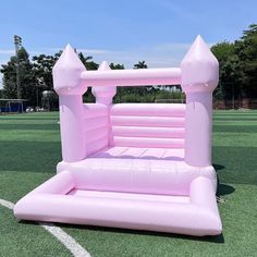 an inflatable pink castle on a soccer field