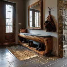 a wooden bench sitting in front of a mirror next to a brick wall with a coat rack on it