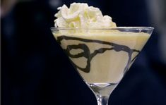 a martini glass filled with ice cream and whipped cream