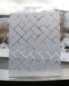 a white card sitting on top of a table next to a snow covered mountain range