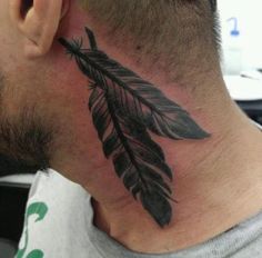 a man with a tattoo on his neck has a black feather hanging from it's side