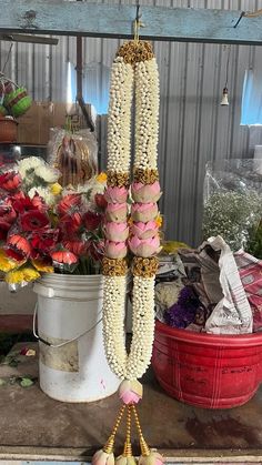 flowers are hanging from the side of a bucket