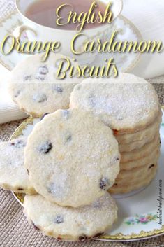 english orange cardamon biscuits on a plate with a cup of tea in the background