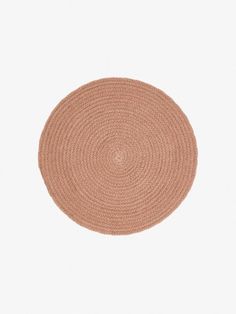 the round rug is made from jute and has a light brown color on it