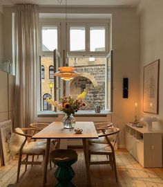 a dining room with a table and chairs next to a window filled with light bulbs